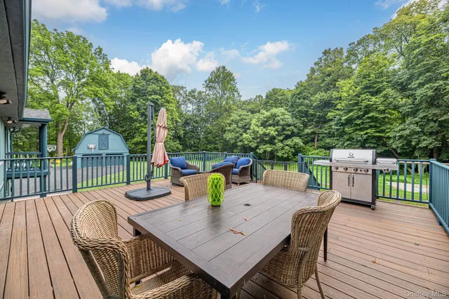 a view of a house with a big yard and large trees