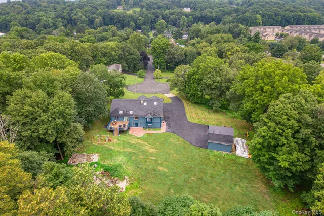 an aerial view of a house with garden space and street view