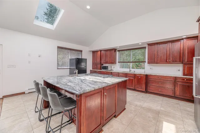 a kitchen with stainless steel appliances granite countertop a stove a sink dishwasher and a wooden cabinets