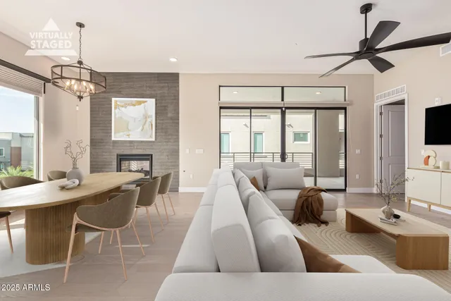 a living room with furniture and a chandelier
