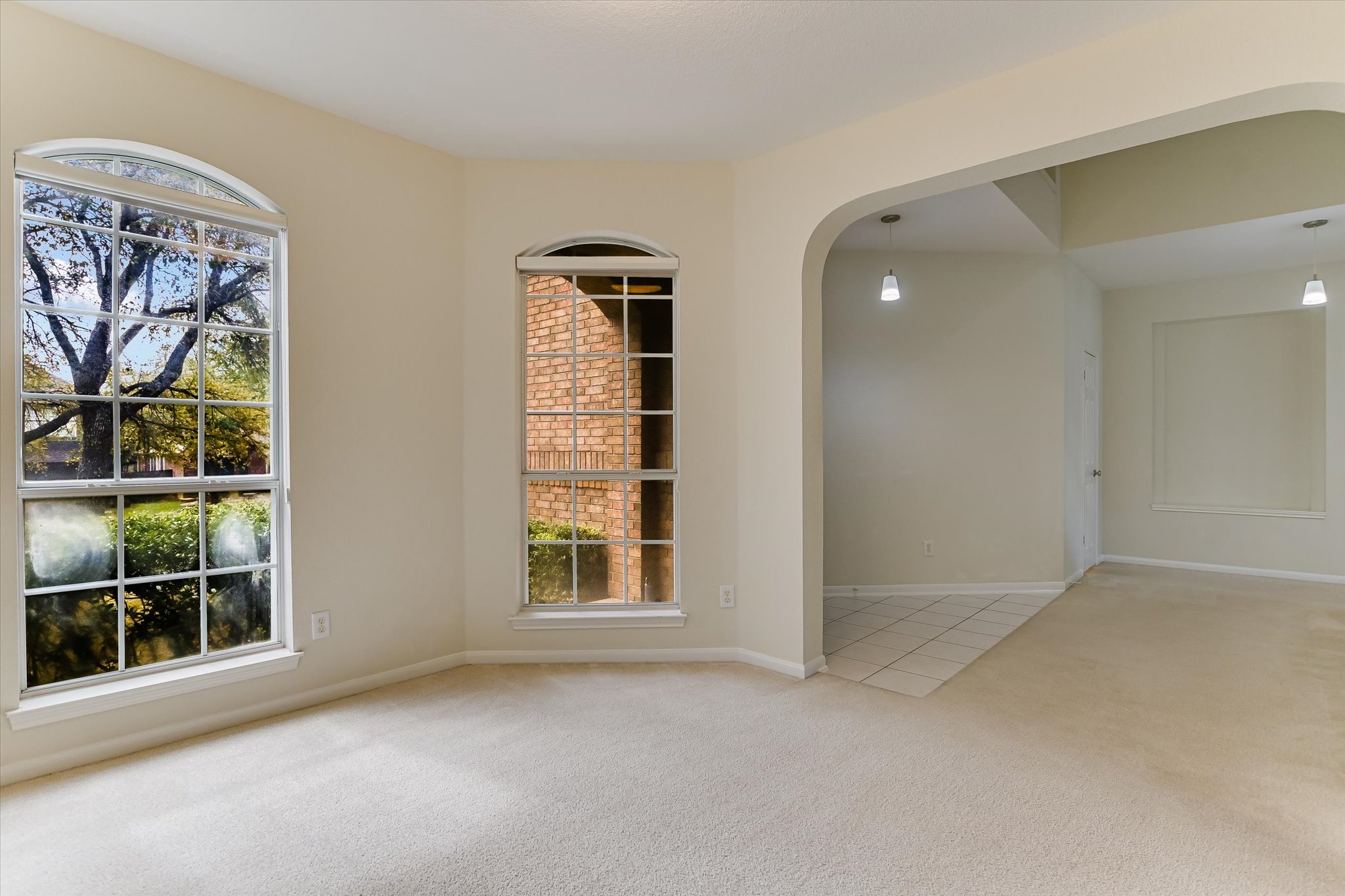 2218 Equestrian Trail Austin, TX 78727 - Photo 11 of 39 Unfurnished room with light colored carpet and arched walkways