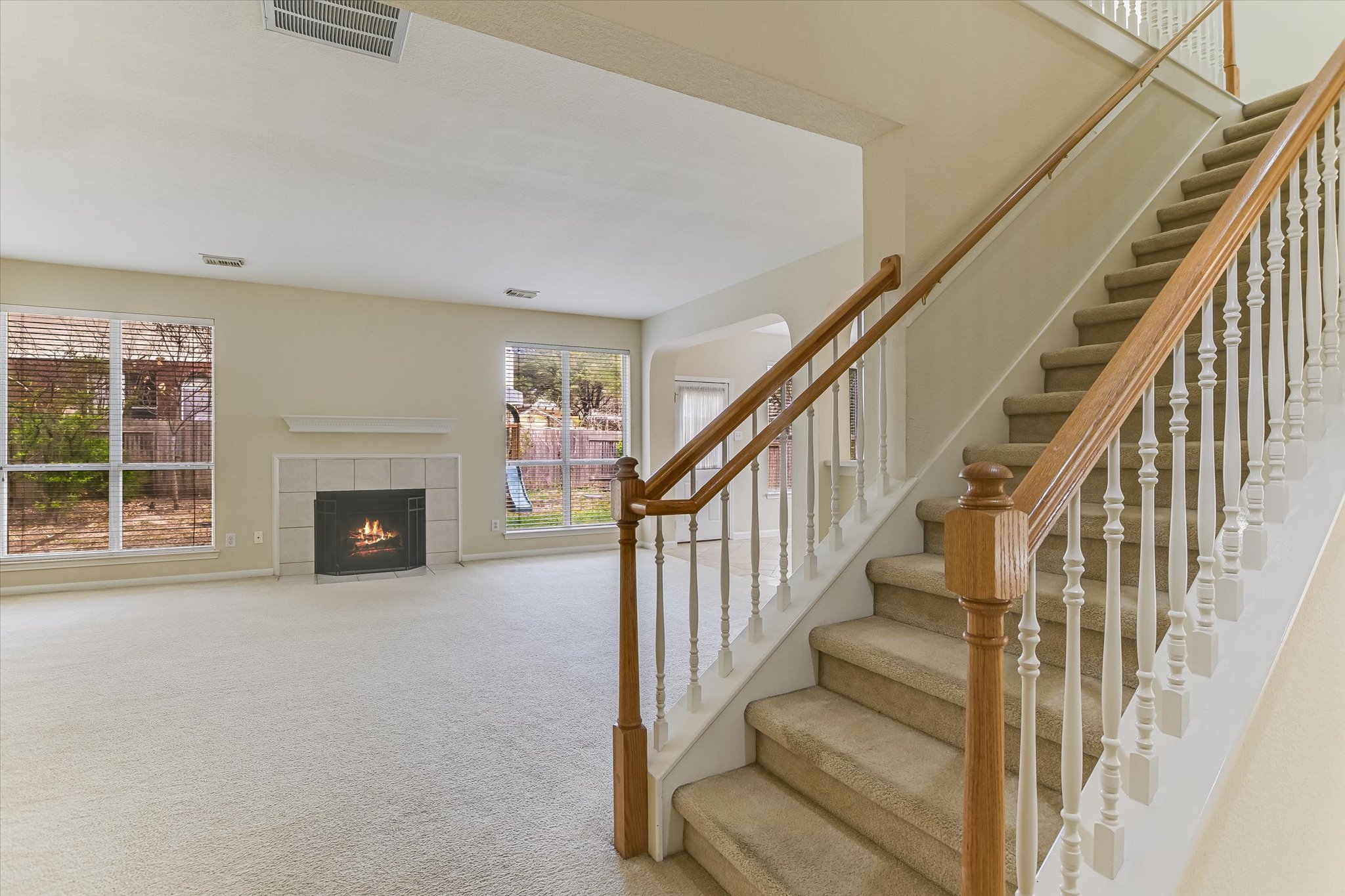 2218 Equestrian Trail Austin, TX 78727 - Photo 22 of 39 Staircase featuring carpet floors and a fireplace