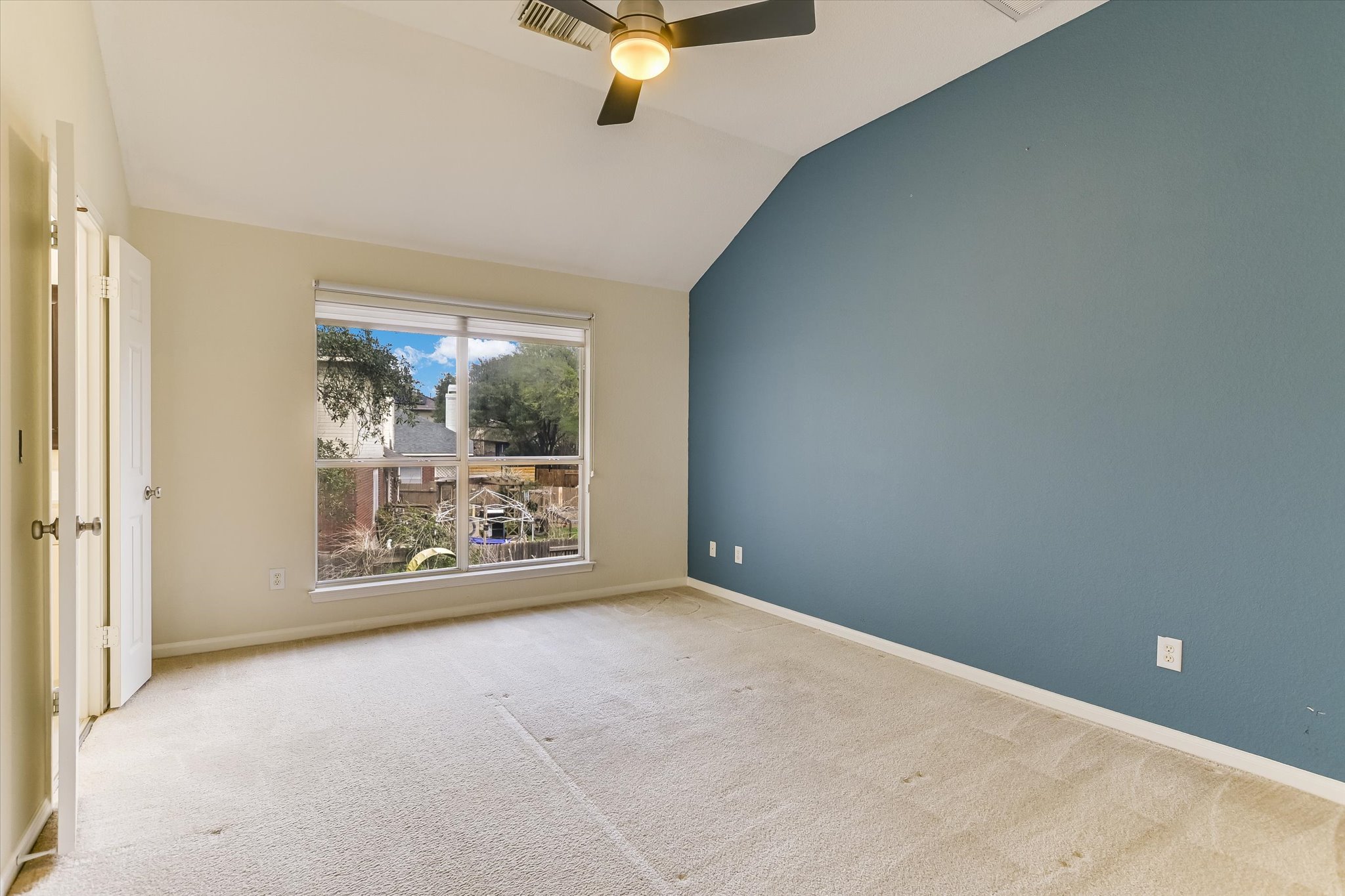 2218 Equestrian Trail Austin, TX 78727 - Photo 26 of 39 Unfurnished room featuring ceiling fan, lofted ceiling, and light carpet