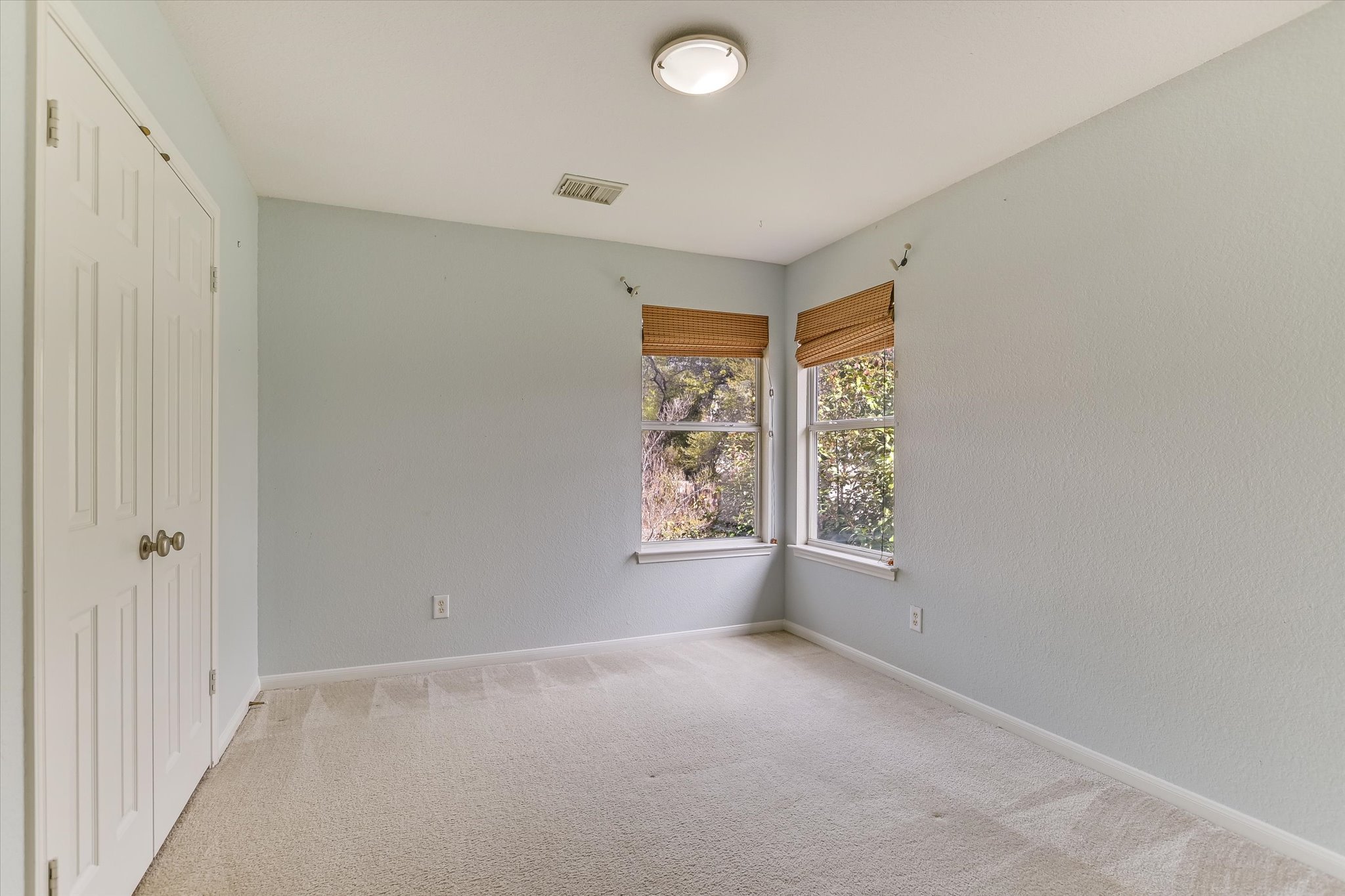 2218 Equestrian Trail Austin, TX 78727 - Photo 34 of 39 Unfurnished bedroom featuring a closet and light carpet
