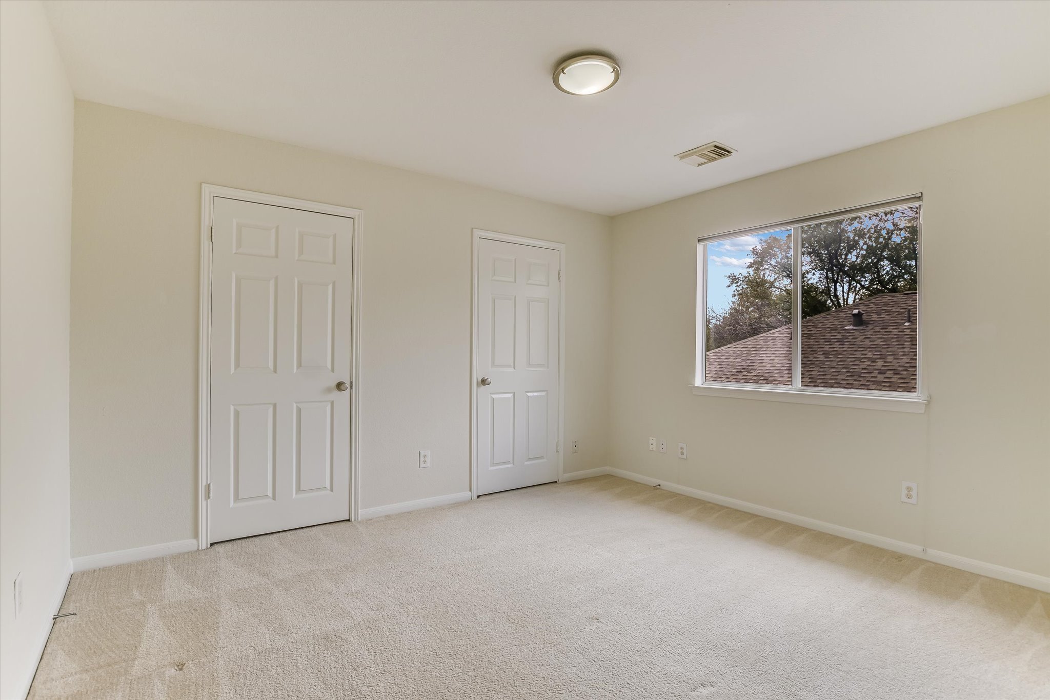 2218 Equestrian Trail Austin, TX 78727 - Photo 36 of 39 Unfurnished bedroom with light carpet and baseboards