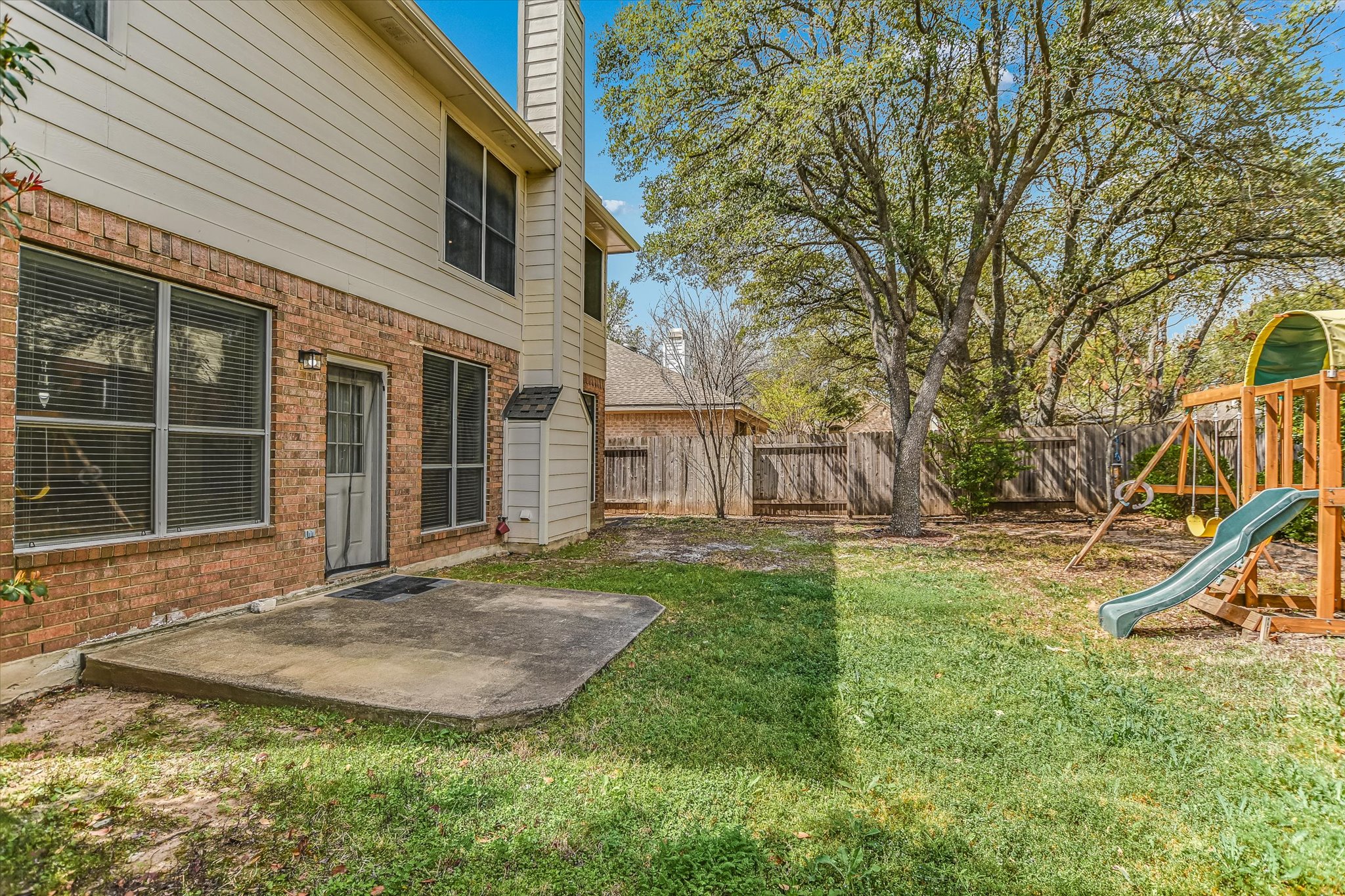 2218 Equestrian Trail Austin, TX 78727 - Photo 38 of 39 Fenced backyard with a playground and a patio area