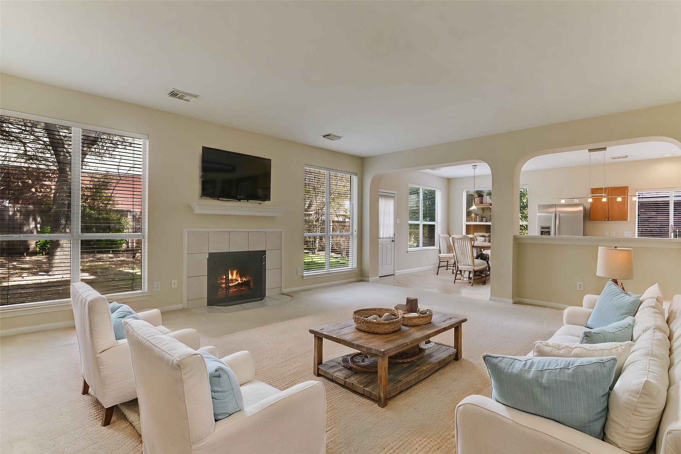 2218 Equestrian Trail Austin, TX 78727 - Photo 4 of 39 Virtually Staged: Living room with arched walkways, and a fireplace