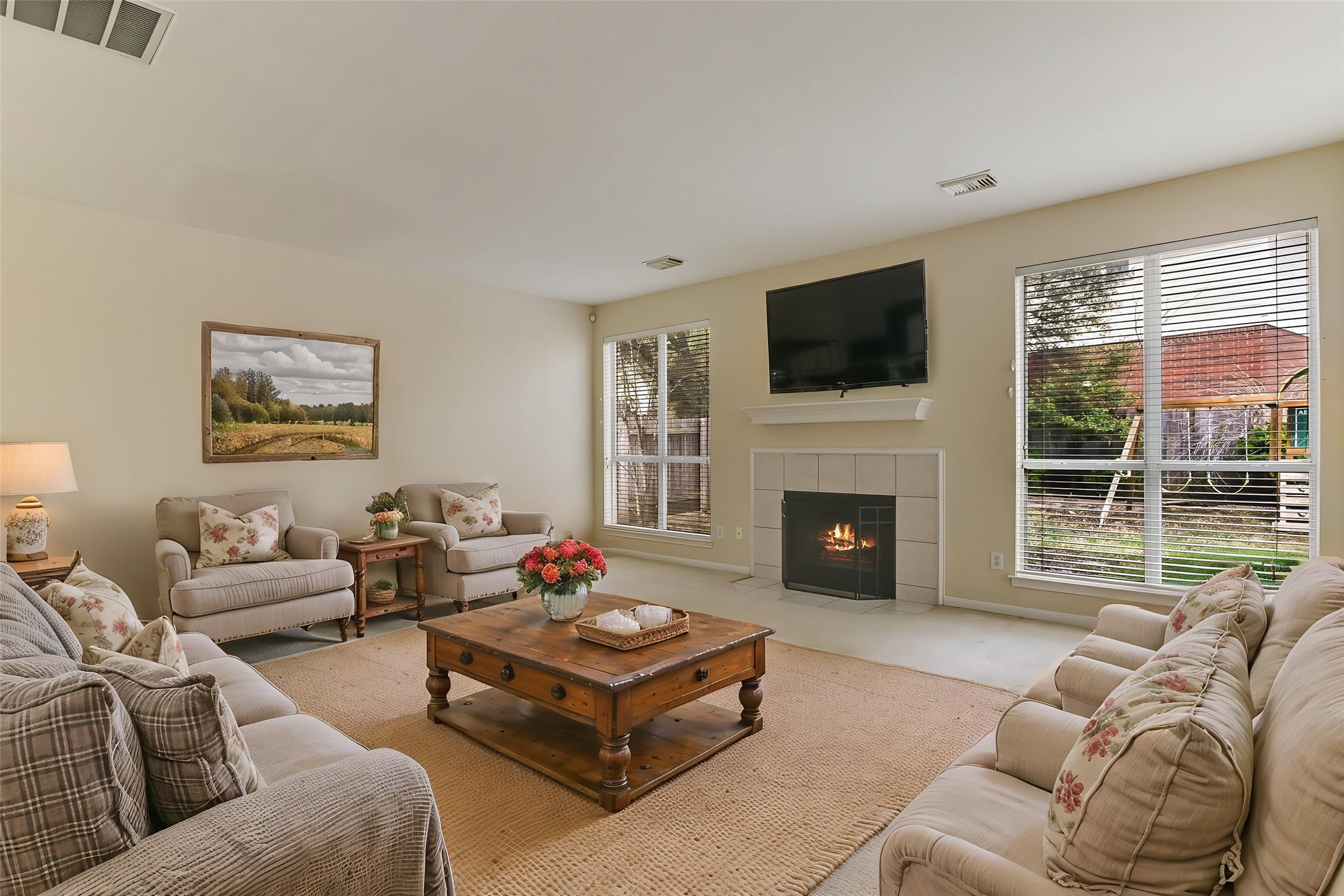2218 Equestrian Trail Austin, TX 78727 - Photo 6 of 39 Virtually Staged: Living area with plenty of natural light, and a tile fireplace