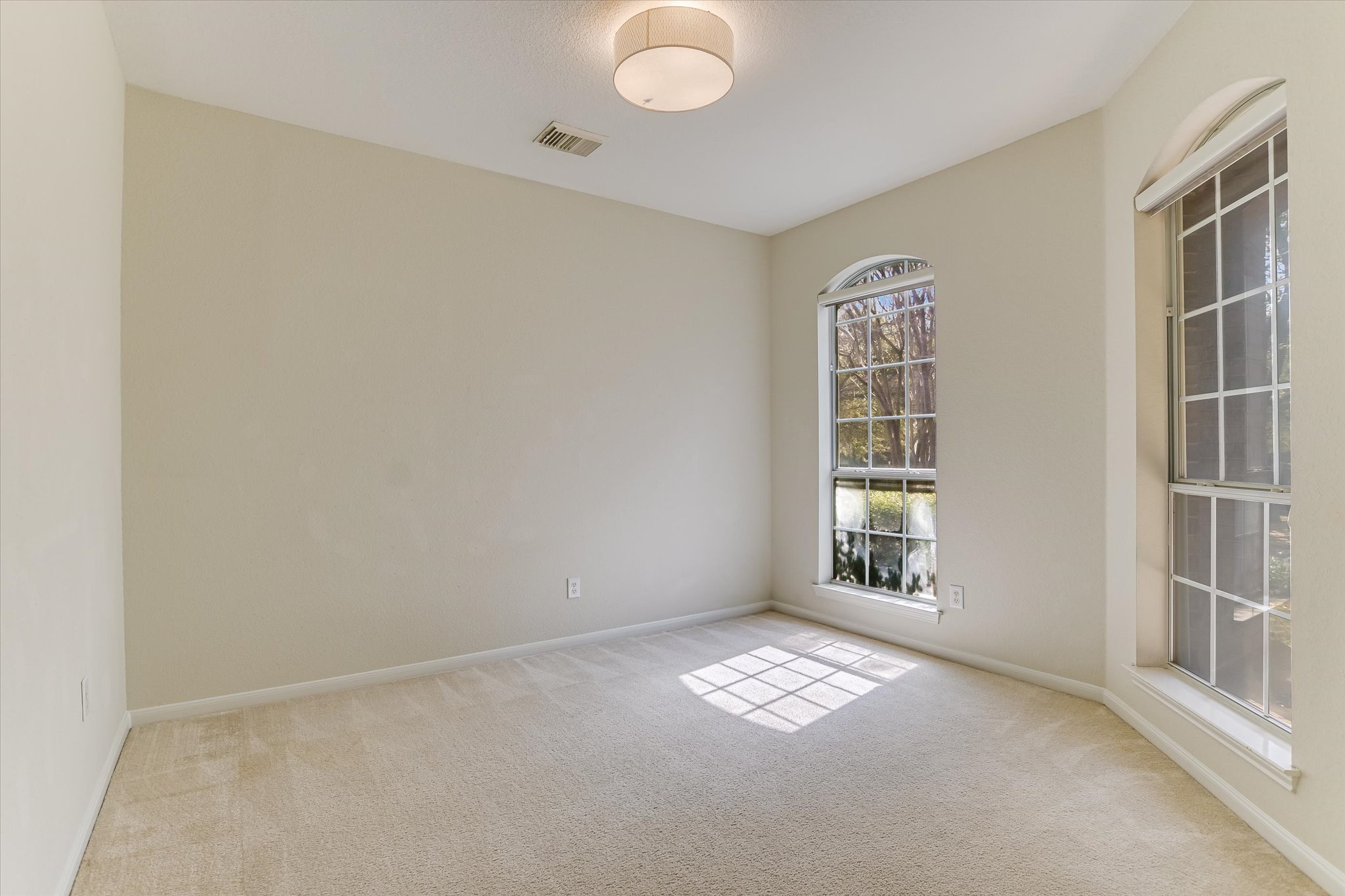 2218 Equestrian Trail Austin, TX 78727 - Photo 10 of 39 Unfurnished room with light colored carpet and baseboards
