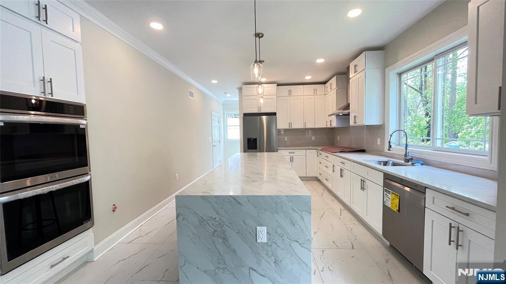 405 Valley Road River Edge, NJ 07661 - Photo 8 of 20 a large kitchen with stainless steel appliances a large counter top