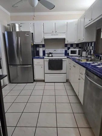 a kitchen with a stove a refrigerator and a sink