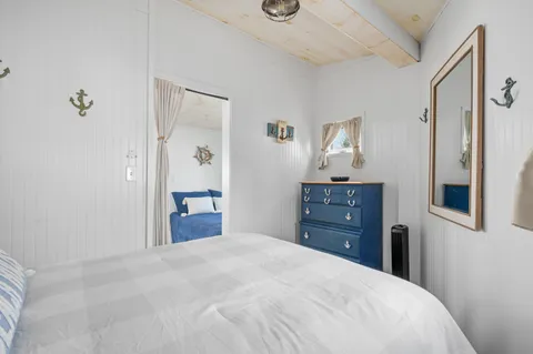 a bedroom with a bed and a dresser