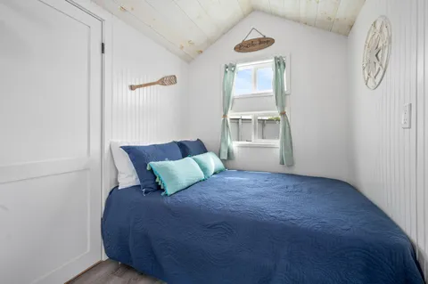 a bedroom with a bed and window
