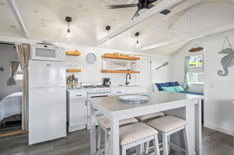 a kitchen with stainless steel appliances cabinets and wooden floor