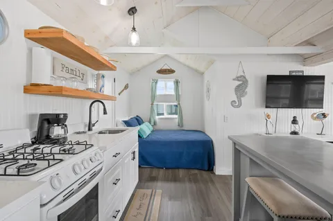 a spacious bedroom with a bed and a flat screen tv