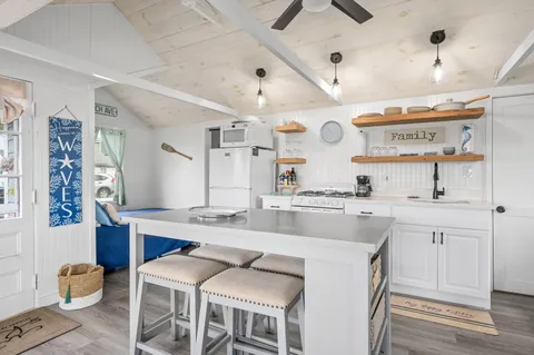 a large kitchen with a table and chairs in it