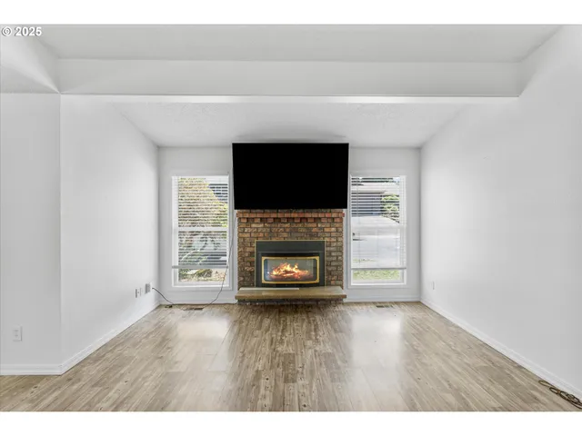 a living room with a fireplace and a flat screen tv