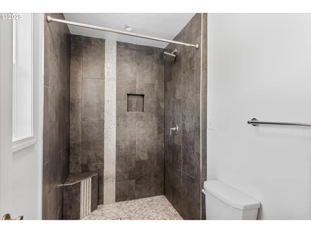a bathroom with a shower and a sink