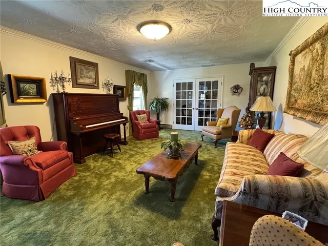 a living room with furniture rug and window