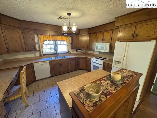 a kitchen with refrigerator stove microwave and cabinets