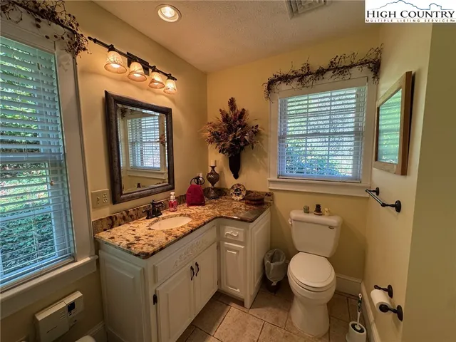 a bathroom with a sink a mirror and a shower
