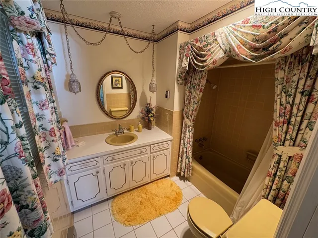 a bathroom with a sink and a washing machine with window