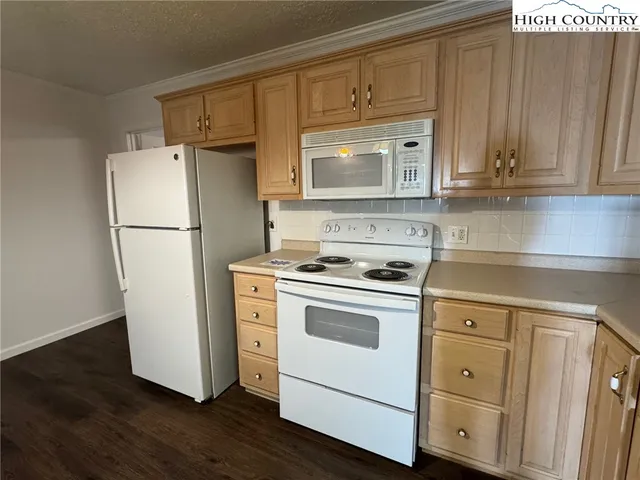 a kitchen with cabinets stainless steel appliances a sink and a window