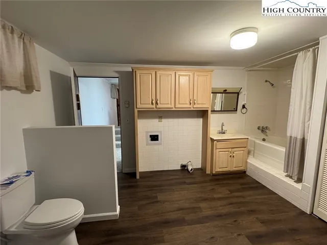 a view of an empty room with fireplace and a window