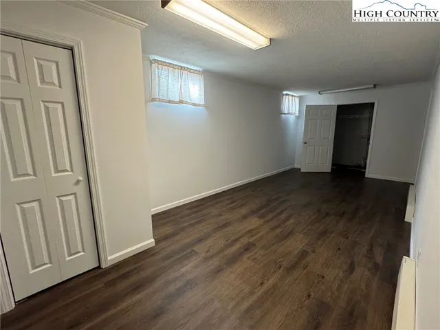 an empty room with windows and closet