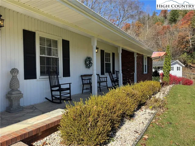 a view of a chairs and table in backyard of the house