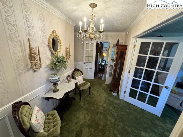 a living room with furniture and a chandelier