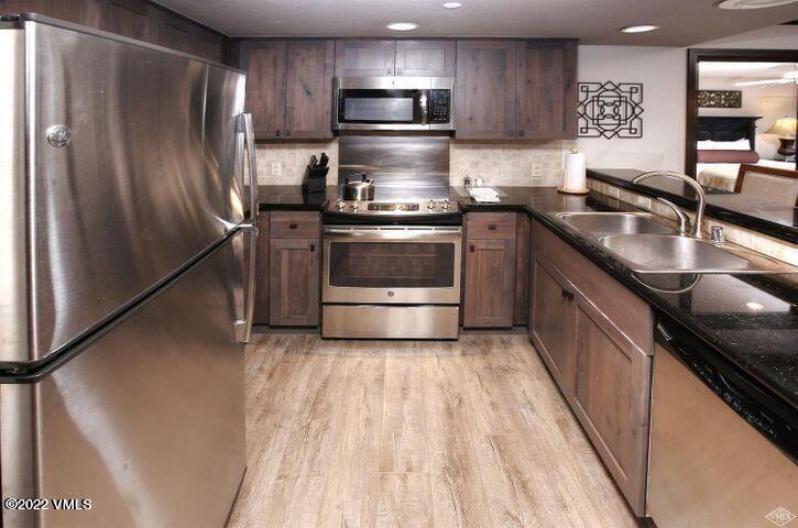 210 Offerson Road, Unit 21227 Beaver Creek, CO 81620 - Photo 4 of 16 a kitchen with granite countertop a sink and stainless steel appliances
