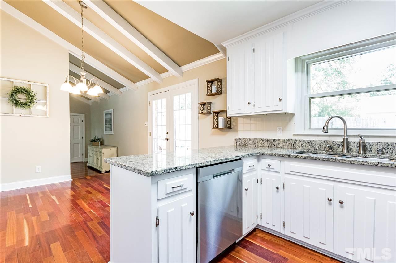 2021 Port Royal Road Raleigh, NC 27609 - Photo 15 of 23 a kitchen with granite countertop white cabinets and white appliances