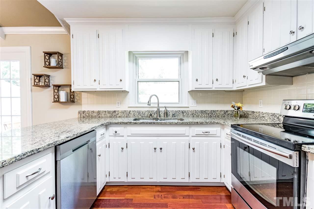 2021 Port Royal Road Raleigh, NC 27609 - Photo 17 of 23 a kitchen with granite countertop white cabinets and stainless steel appliances