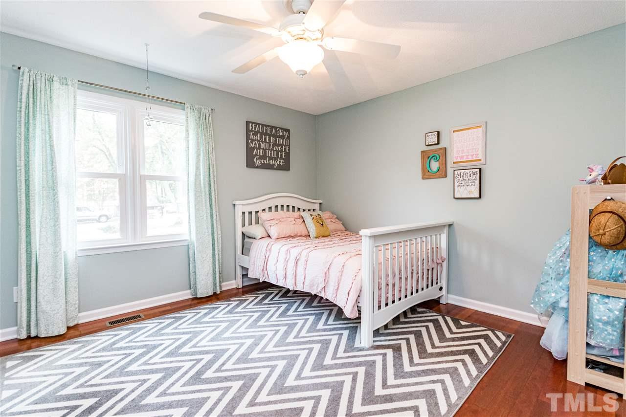 2021 Port Royal Road Raleigh, NC 27609 - Photo 19 of 23 a bedroom with a bed and wooden floor