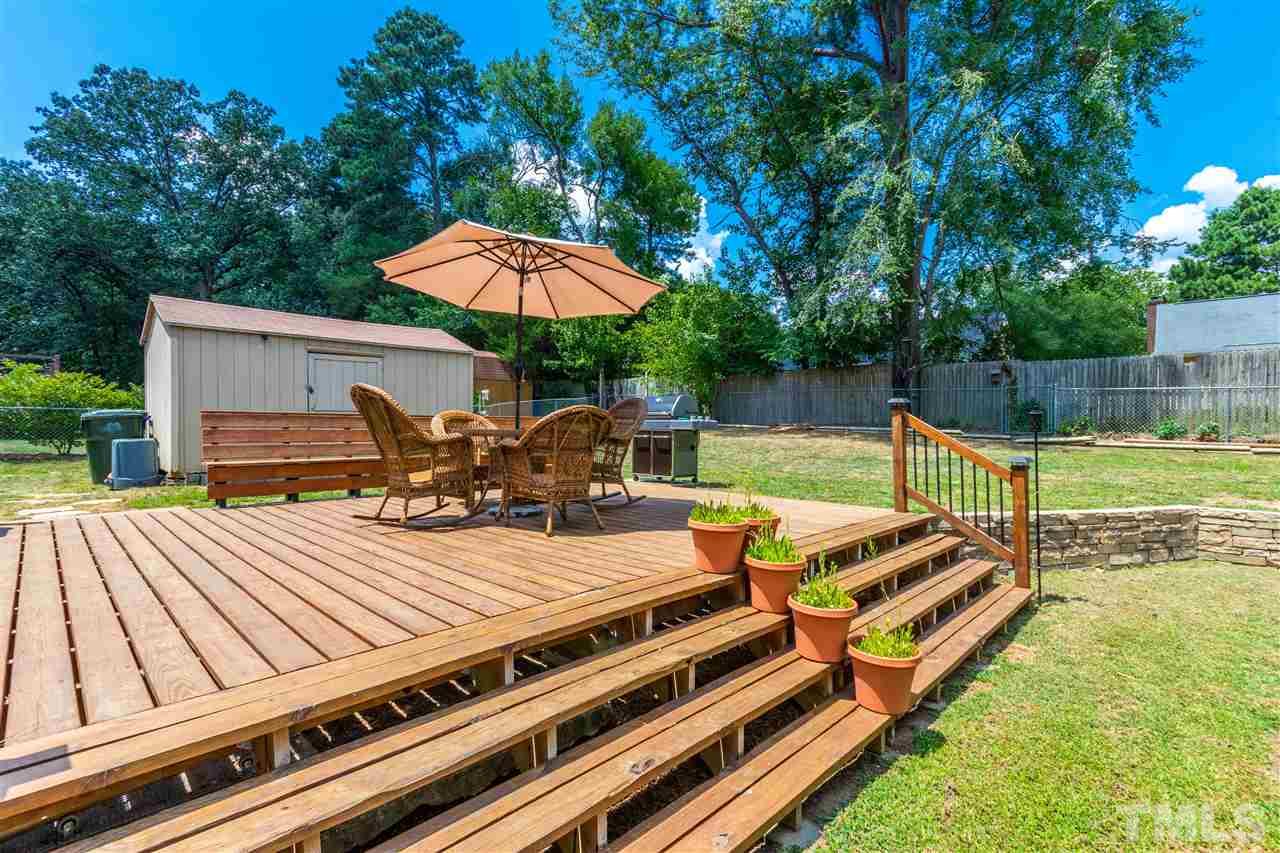 2021 Port Royal Road Raleigh, NC 27609 - Photo 3 of 23 a view of a patio with a table chairs and a swimming pool