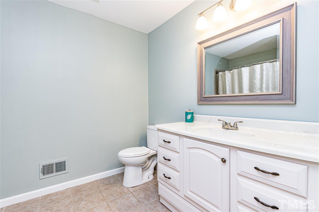 2021 Port Royal Road Raleigh, NC 27609 - Photo 21 of 23 a bathroom with a granite countertop toilet and sink