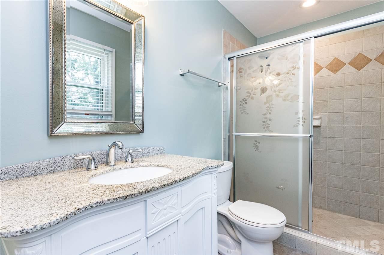 2021 Port Royal Road Raleigh, NC 27609 - Photo 23 of 23 a bathroom with a granite countertop sink toilet and shower
