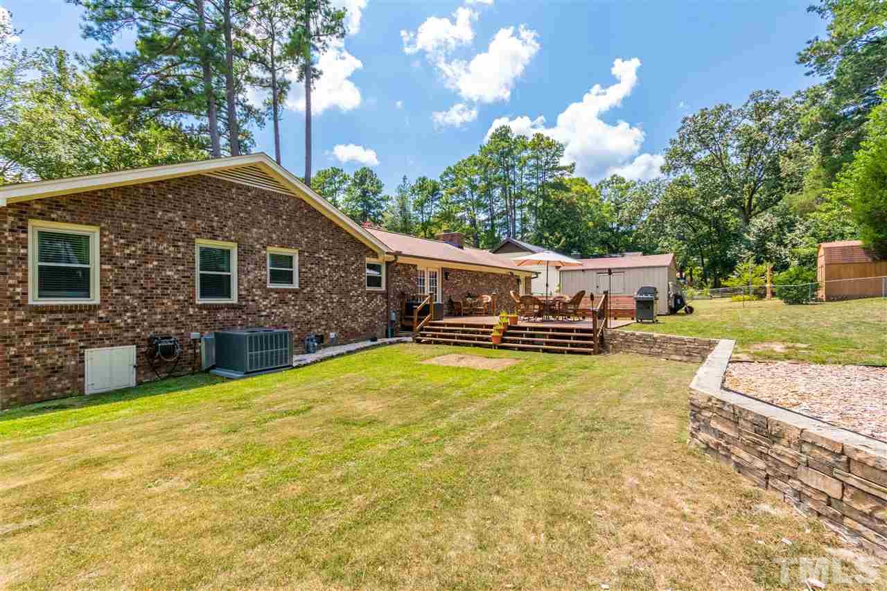 2021 Port Royal Road Raleigh, NC 27609 - Photo 5 of 23 a view of a house with swimming pool and a yard