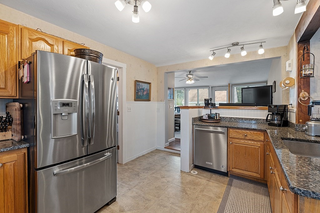 8 Perham Street Chelmsford, MA 01824 - Photo 11 of 42 a kitchen with stainless steel appliances granite countertop a refrigerator and a sink