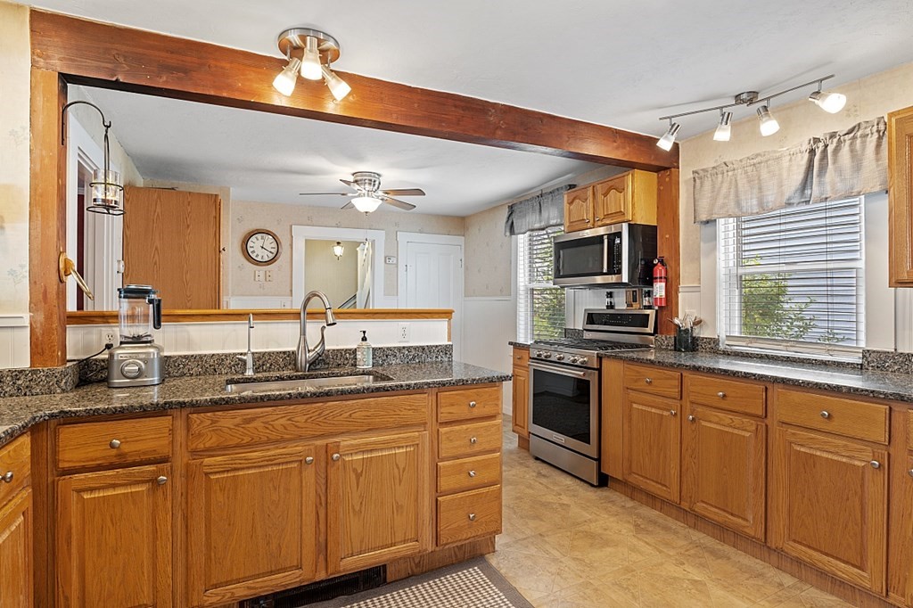 8 Perham Street Chelmsford, MA 01824 - Photo 13 of 42 a kitchen with stainless steel appliances granite countertop a sink and cabinets