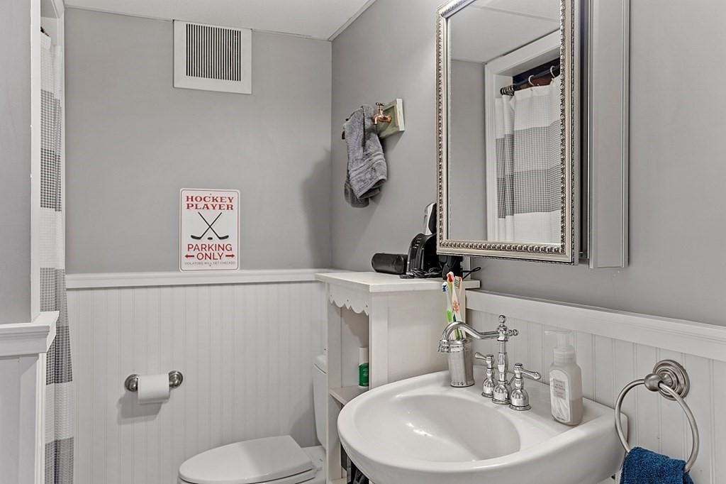 8 Perham Street Chelmsford, MA 01824 - Photo 39 of 42 a bathroom with a toilet a sink and mirror