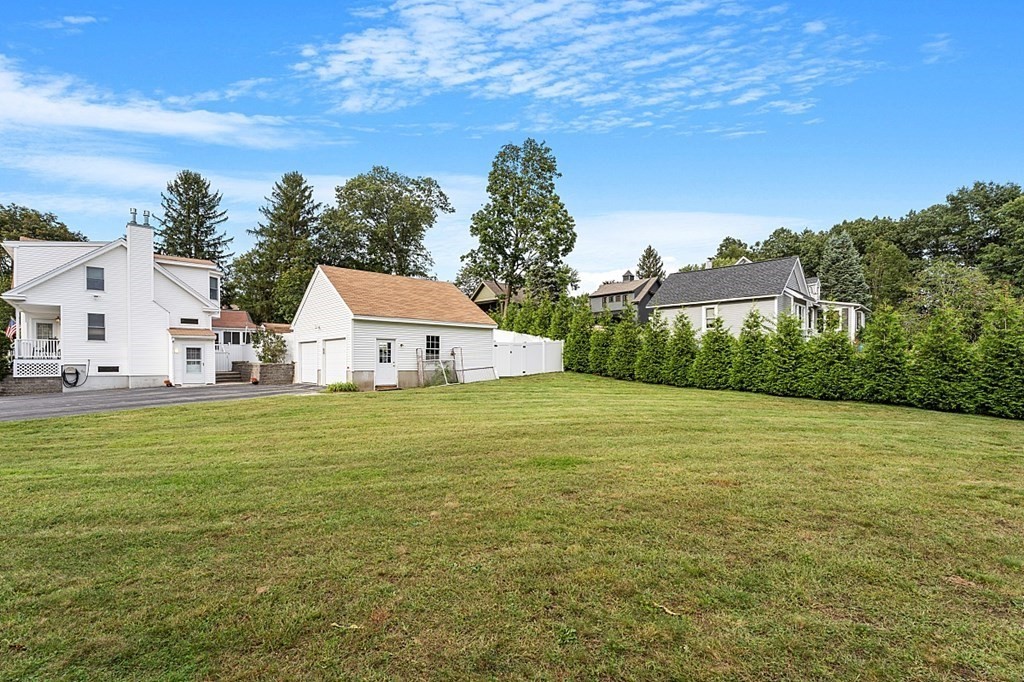 8 Perham Street Chelmsford, MA 01824 - Photo 5 of 42 a view of a white house with a yard