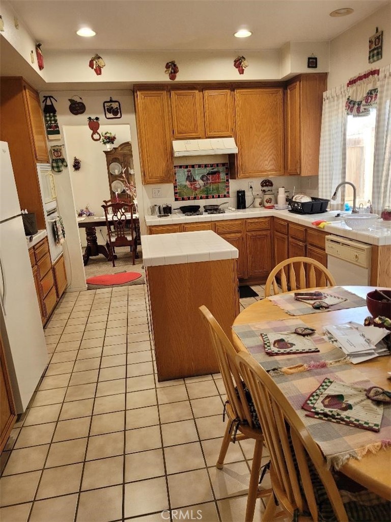 866 Homestead Road Corona, CA 92878 - Photo 13 of 15 a kitchen with stainless steel appliances a stove a sink a refrigerator and cabinets