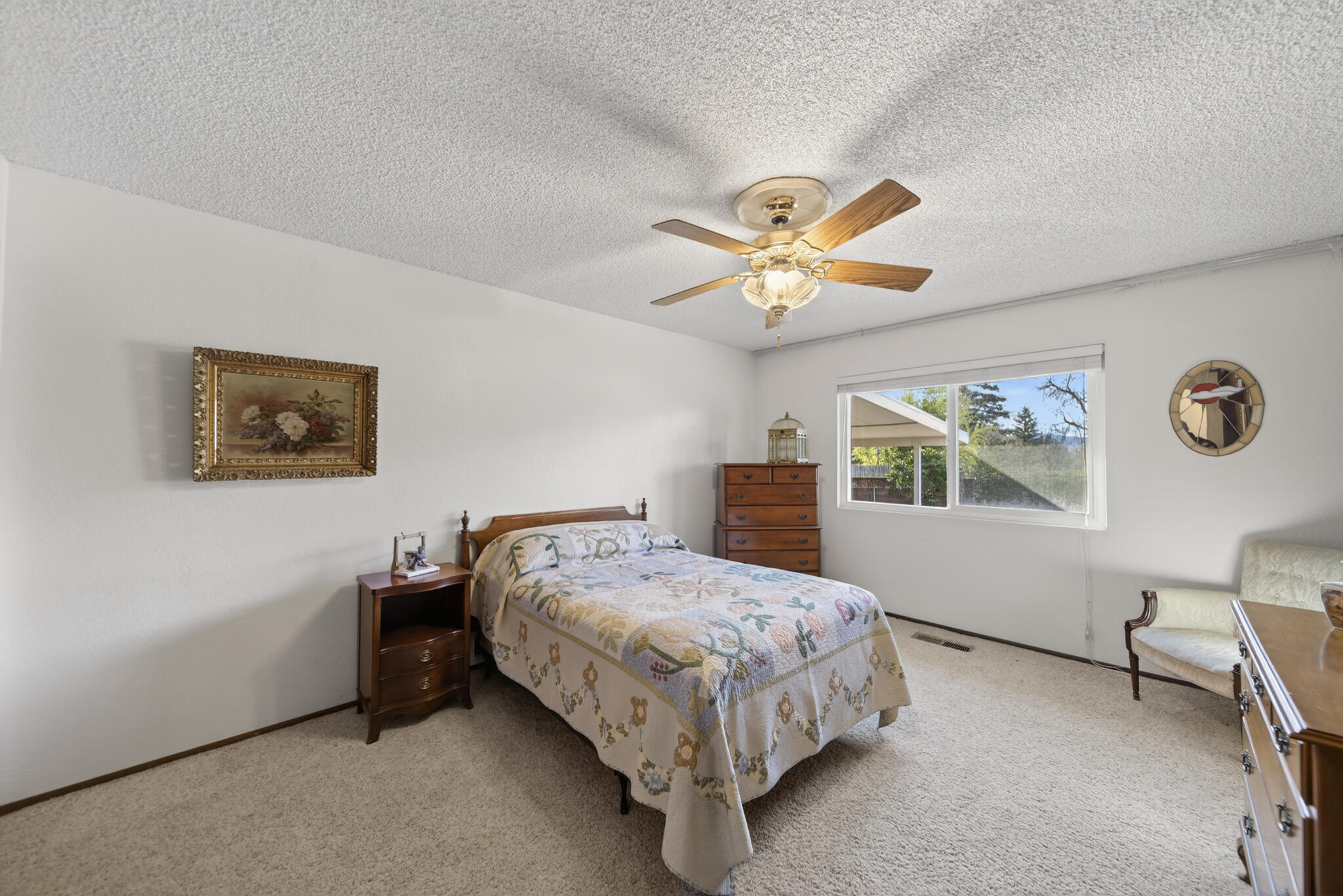3605 Tamarack Drive Redding, CA 96003 - Photo 23 of 49 a bedroom with a bed and a chandelier