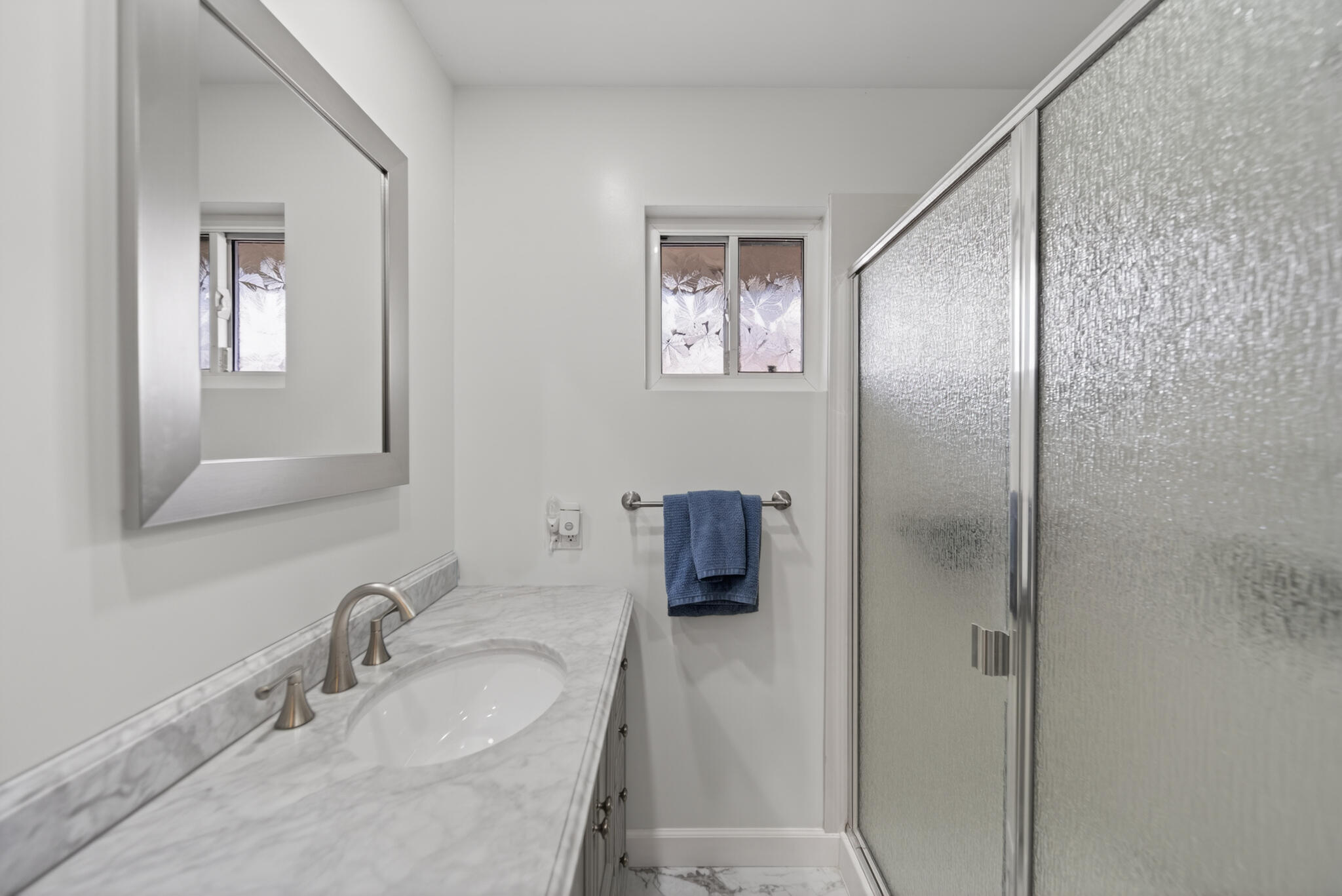 3605 Tamarack Drive Redding, CA 96003 - Photo 27 of 49 a bathroom with a granite countertop sink a mirror and shower