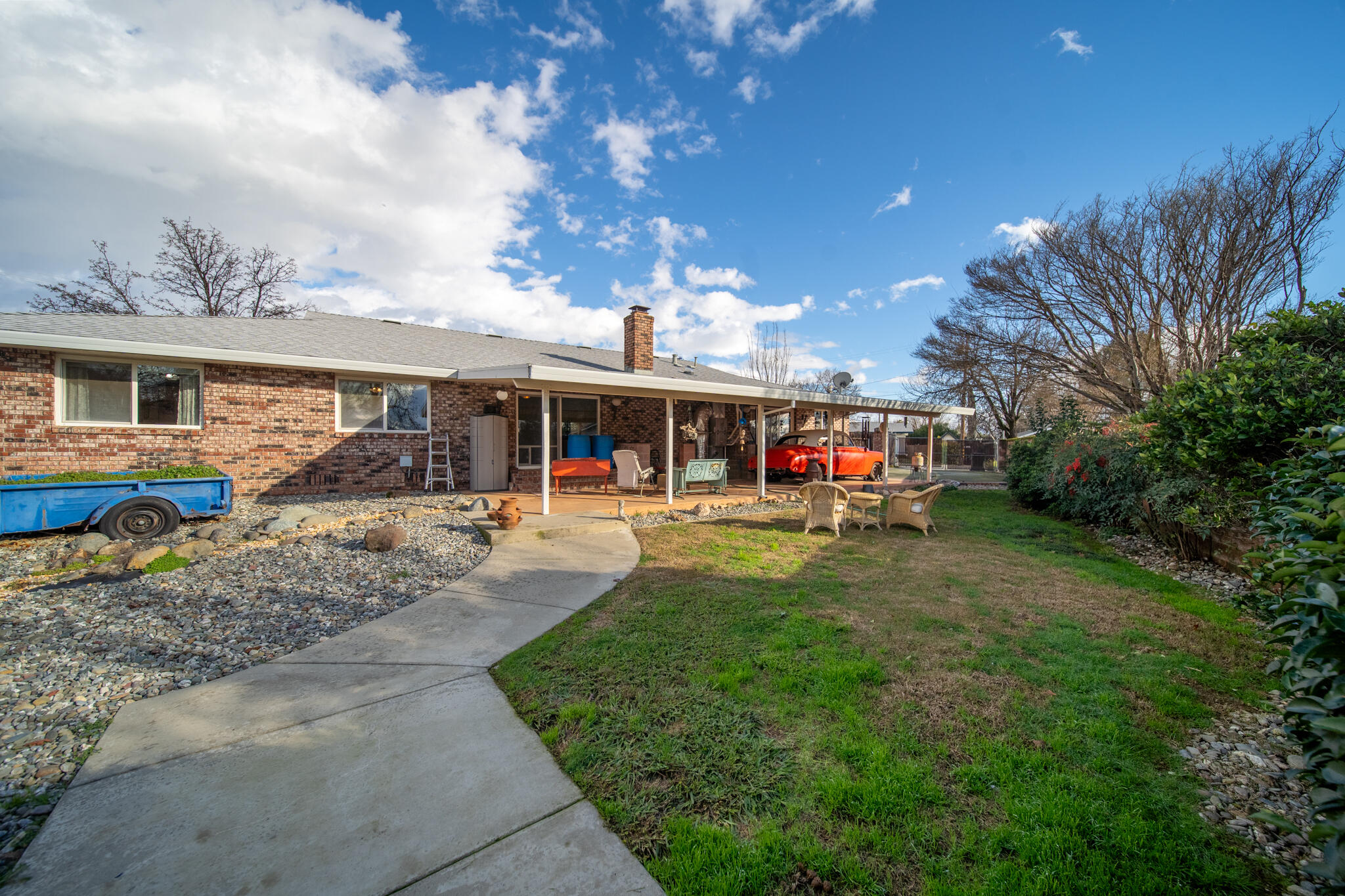 3605 Tamarack Drive Redding, CA 96003 - Photo 32 of 49 a view of a house with backyard sitting area and garden