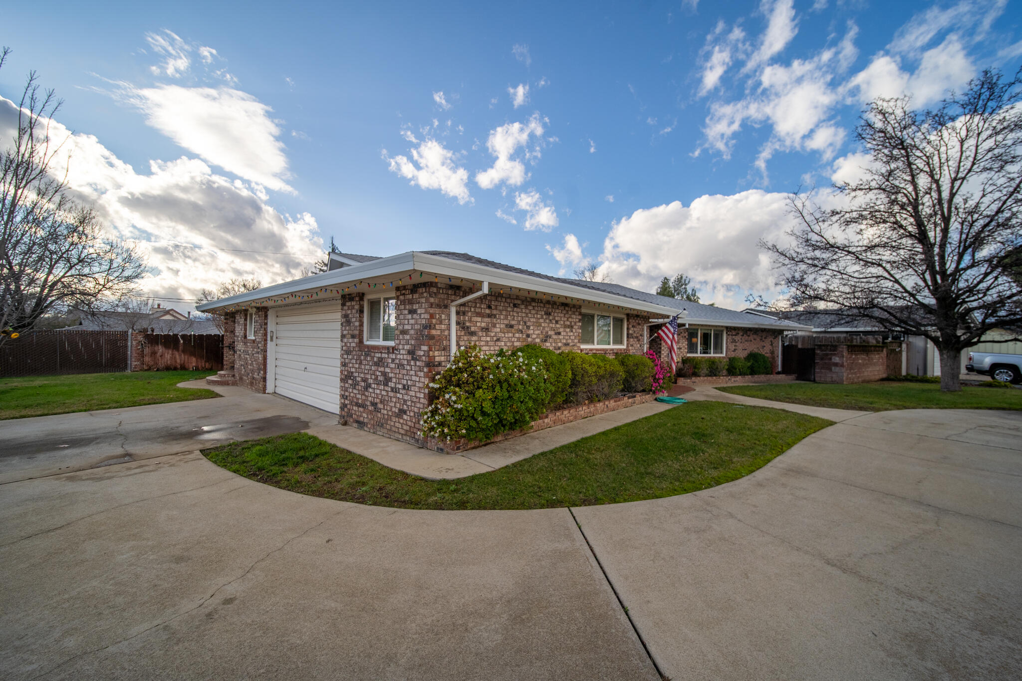 3605 Tamarack Drive Redding, CA 96003 - Photo 43 of 49 a front view of a house with a garden and a yard