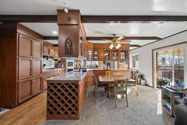a room with stainless steel appliances kitchen island granite countertop furniture and a kitchen view