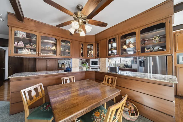 a living room with stainless steel appliances kitchen island granite countertop furniture and a kitchen view